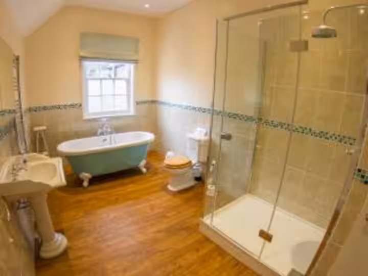Bathroom with roll-top bath and separate shower